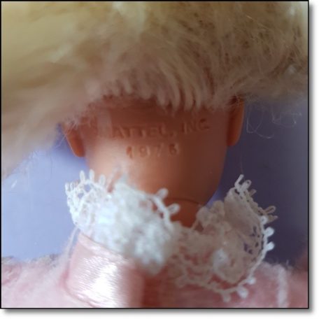 Dombornyomott Mattel Inc 1976 felirat a vintage játék baba tarkóján közelről